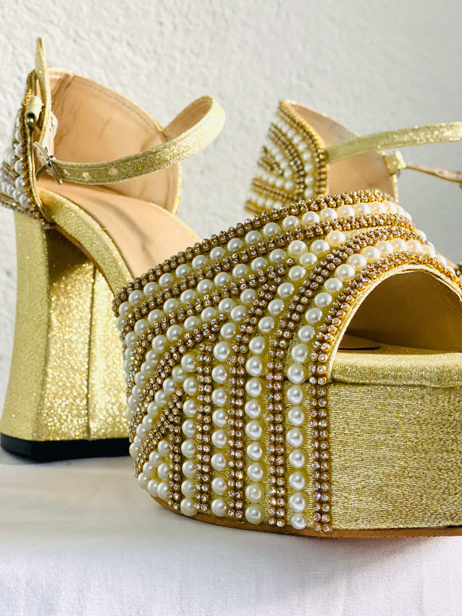 Founder fitting a bride with an Aurelia Heels sample shoe in the atelier